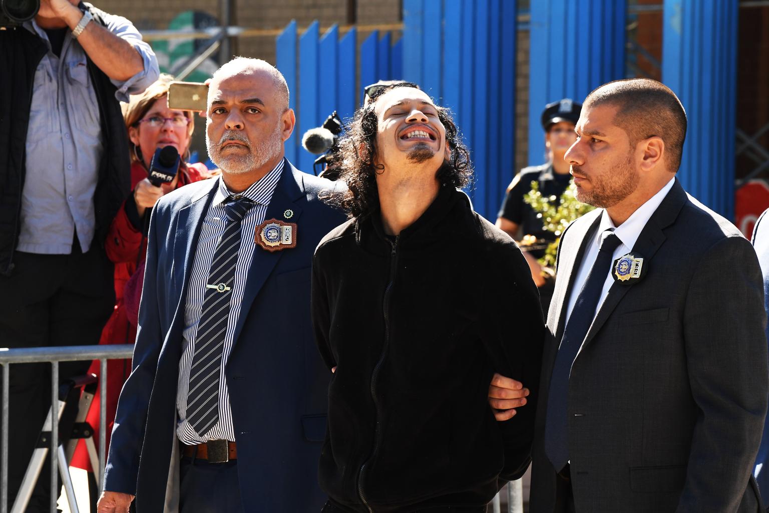 Man accused of pushing girlfriend and baby off NYC balcony smiles as he’s led away by cops