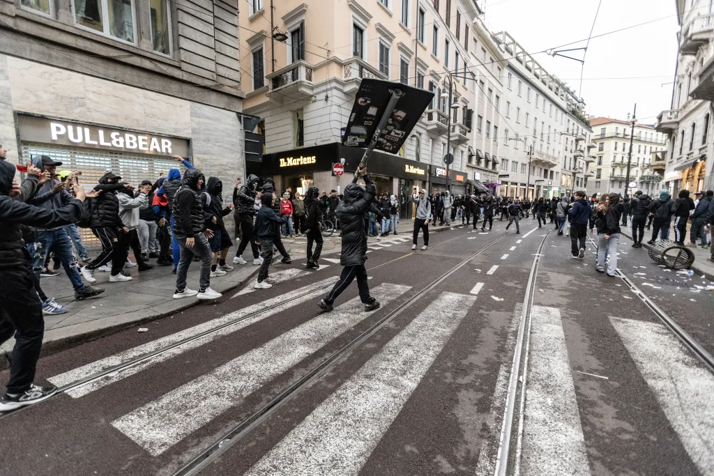 Italian priest gives protesters the middle finger while protecting his congregation from rioters