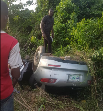 Man climbs his overturned car to take photos after he survived ghastly accident in Ondo state