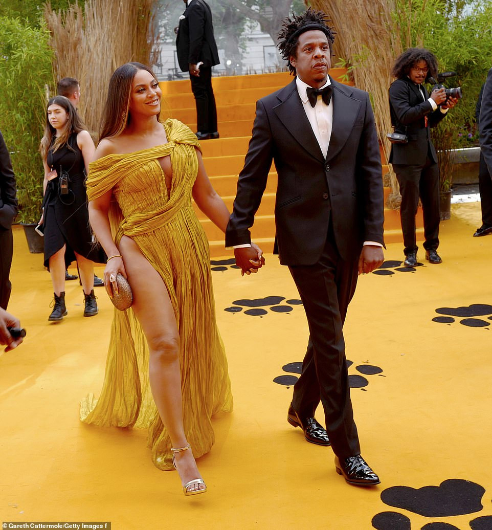 Beyonc commands attention in a gold asymmetric gown as she joins husband Jay-Z at London's premiere of The Lion King (Photos)
