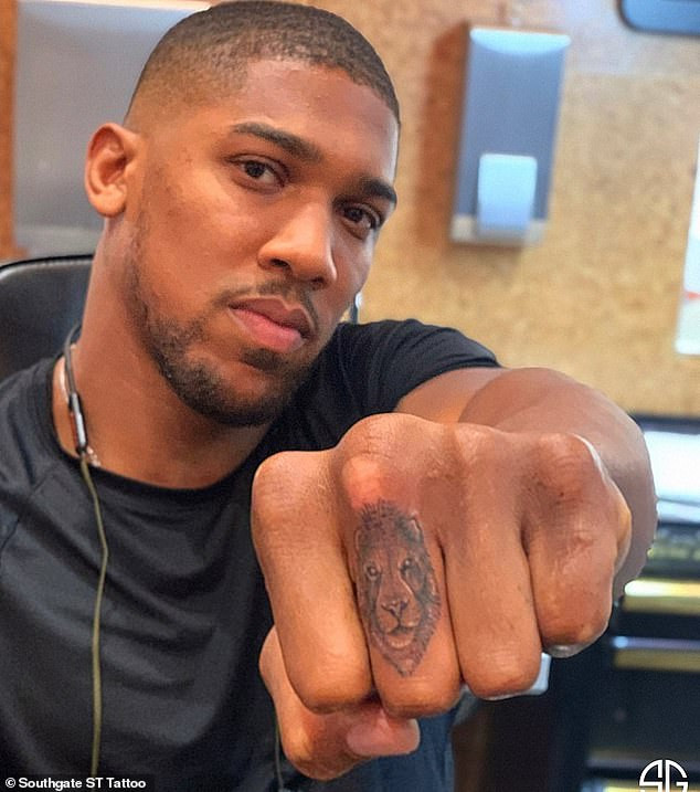 Anthony Joshua shows off new lion tattoo on his middle finger
