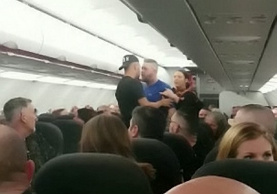 Plane forced to make an emergency landing after brawl breaks out between seven male passengers(video)