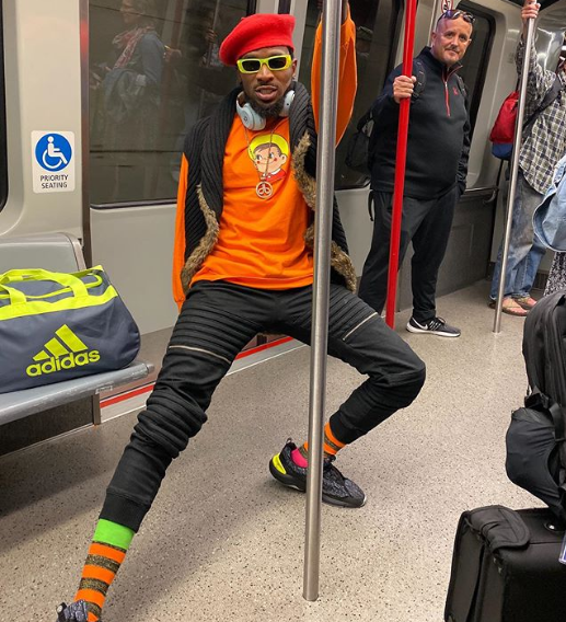 Caption this 'playful' photo of Dbanj inside a train in US