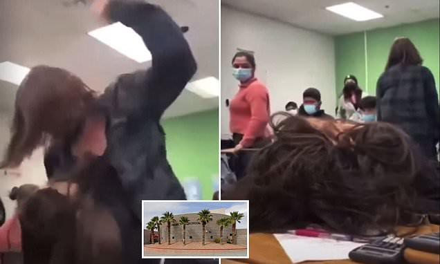Horrific moment a female student punches another girl 30 times while others laugh and watch (video)