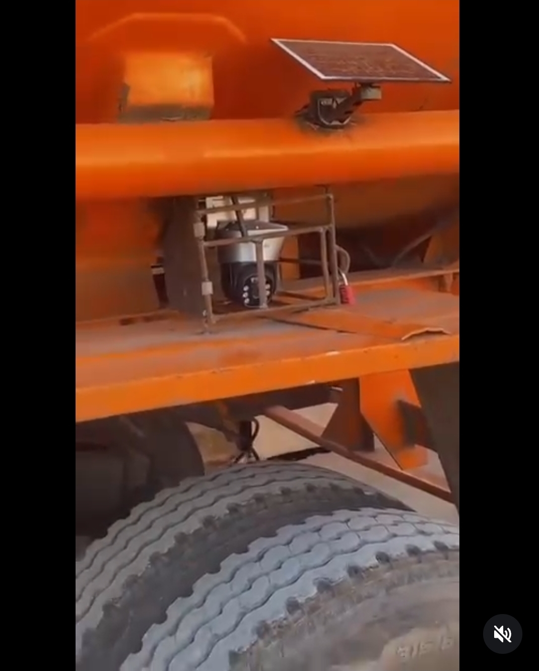 Men react after spotting CCTV camera and solar panel installed on fuel tanker to monitor driver