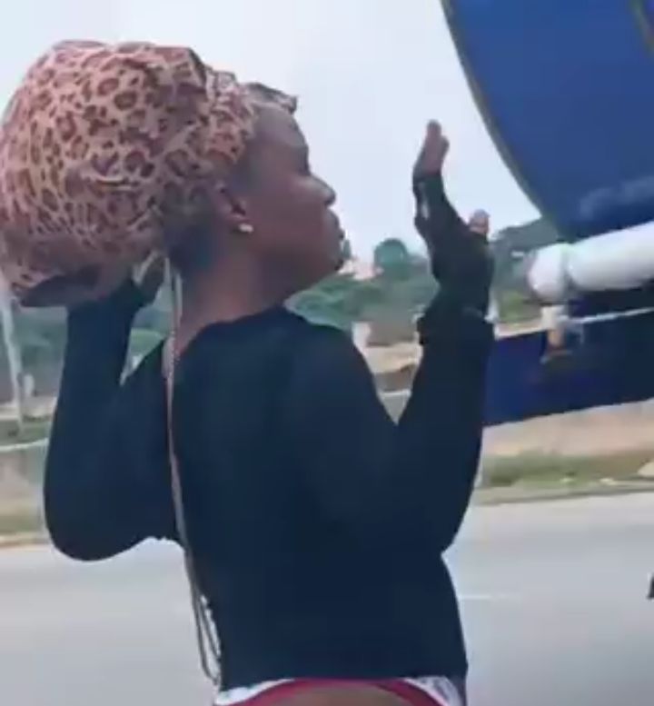 Woman found behaving strangely after allegedly being dumped by roadside in Abuja (video)
