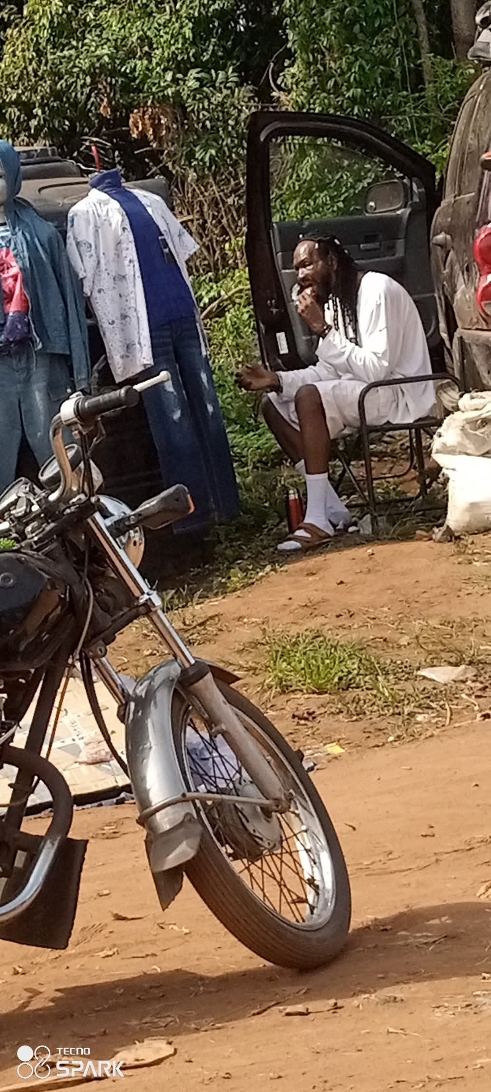 Outrage as man shares photo of former Nollywood actor Sylvester Madu selling clothes and eating on bushy road