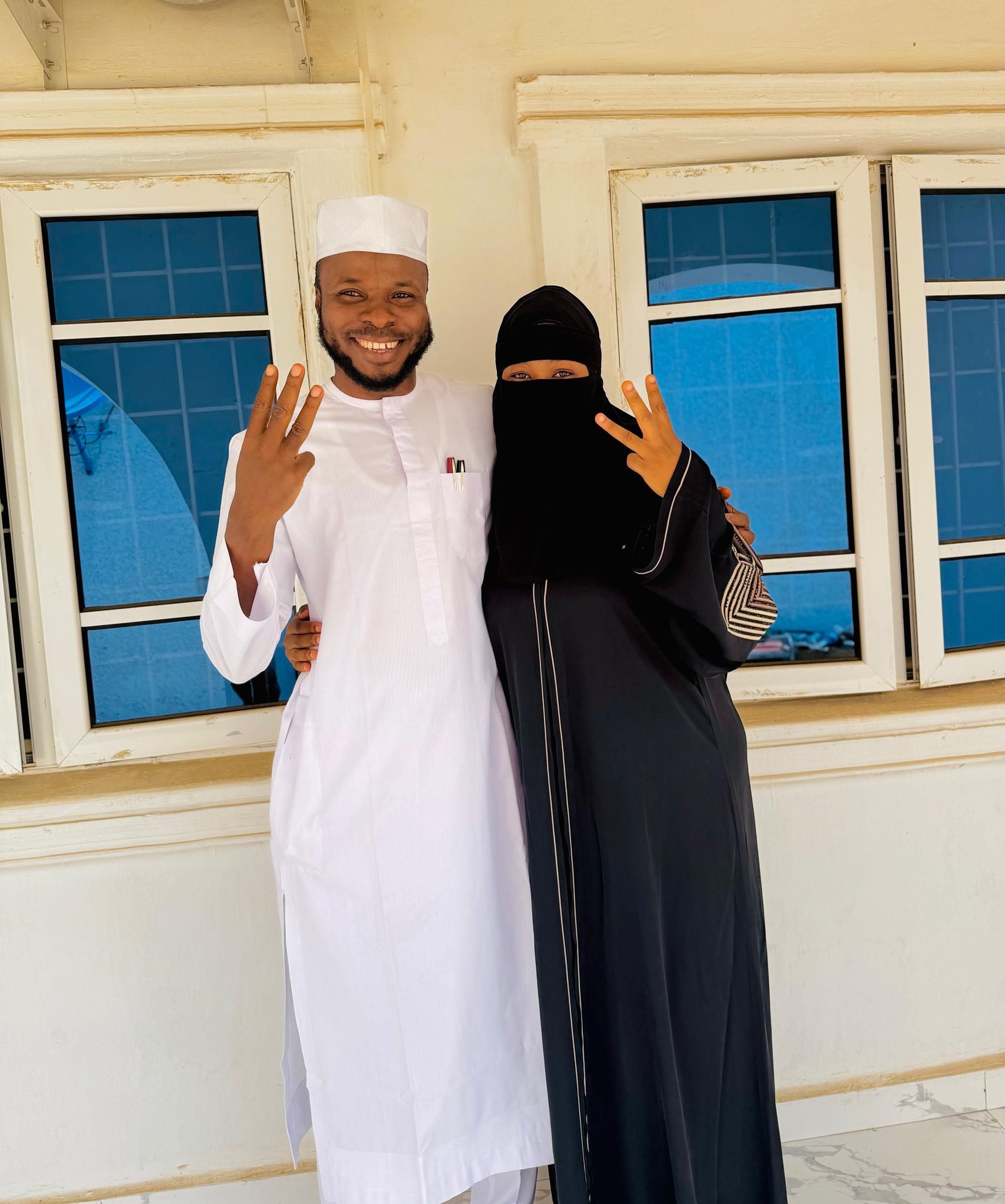 The three fingers we raised symbolize available spaces for additional 3 wives - Nigerian man says as he poses with his wife on their third wedding anniversary