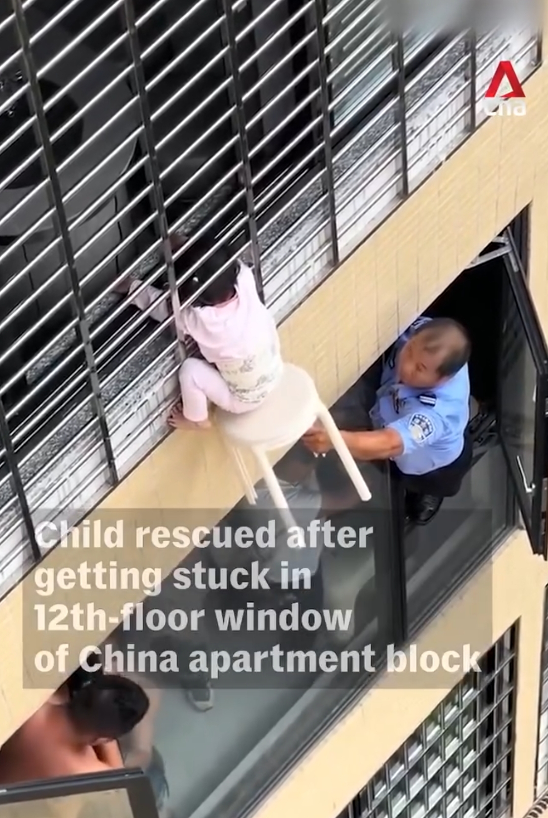 Residents hold up stool to save toddler dangling from 12th-floor window in China