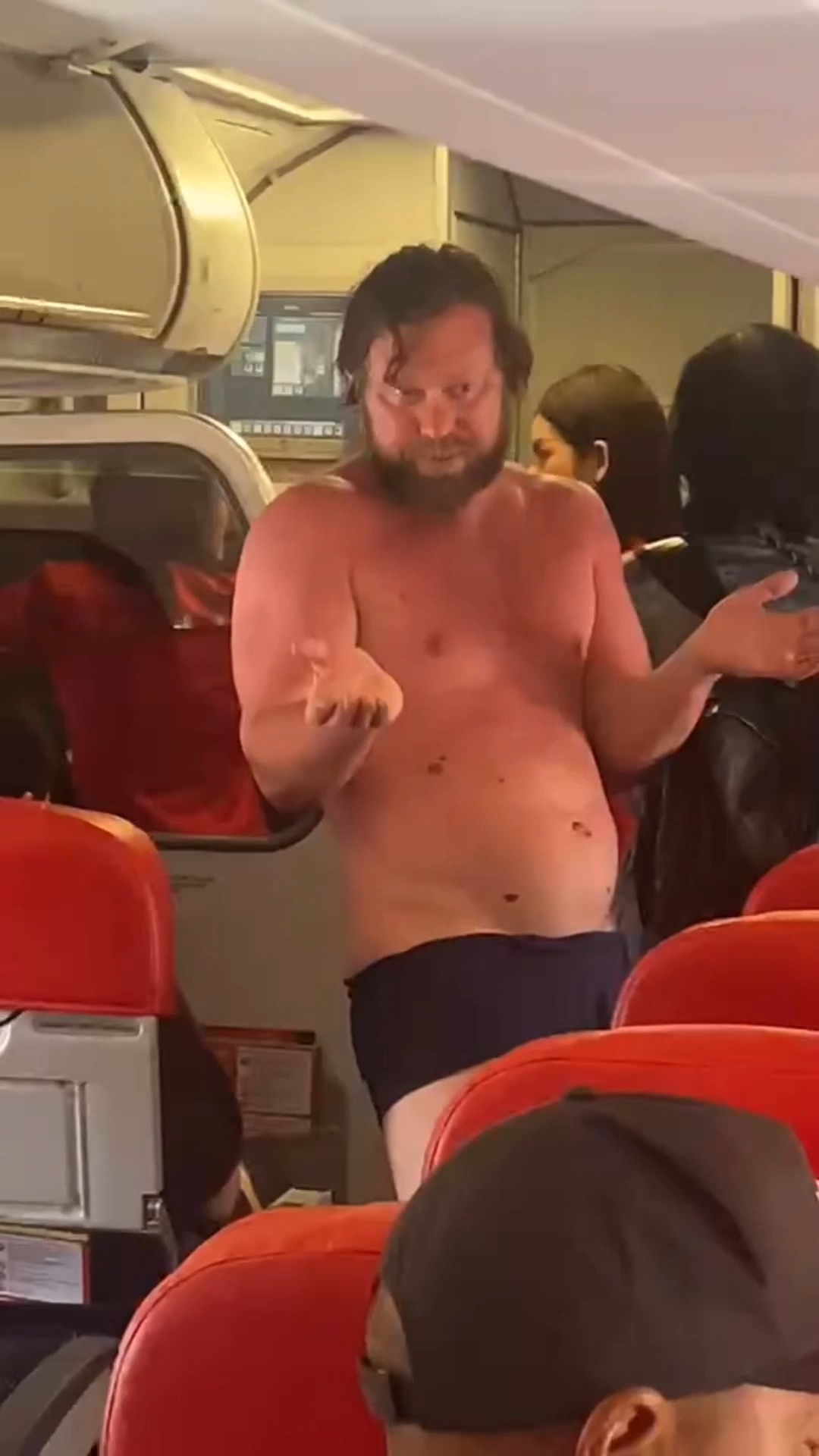Drunk passenger ejected from flight after str!pping off clothes and attempting to jump off plane (video)