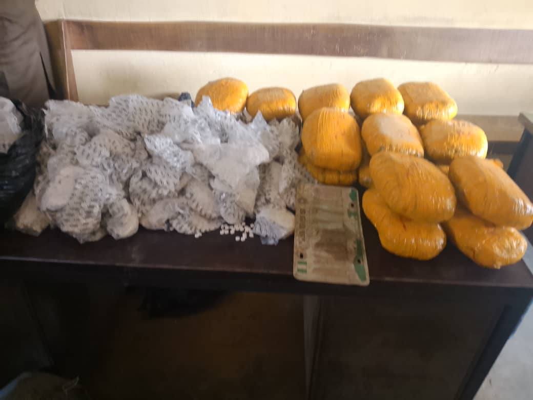 Police officers conducting forensic examination of seized items