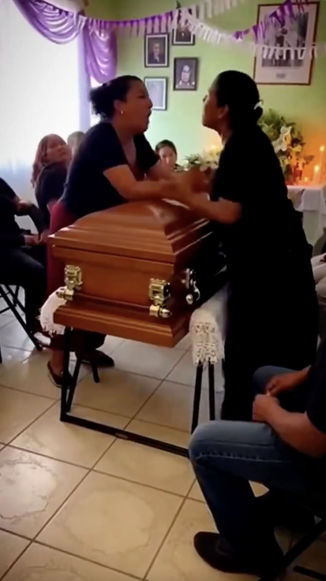 Video captures women fighting across c offin at funeral after learning they both dated the man whose funeral was taking place (video)