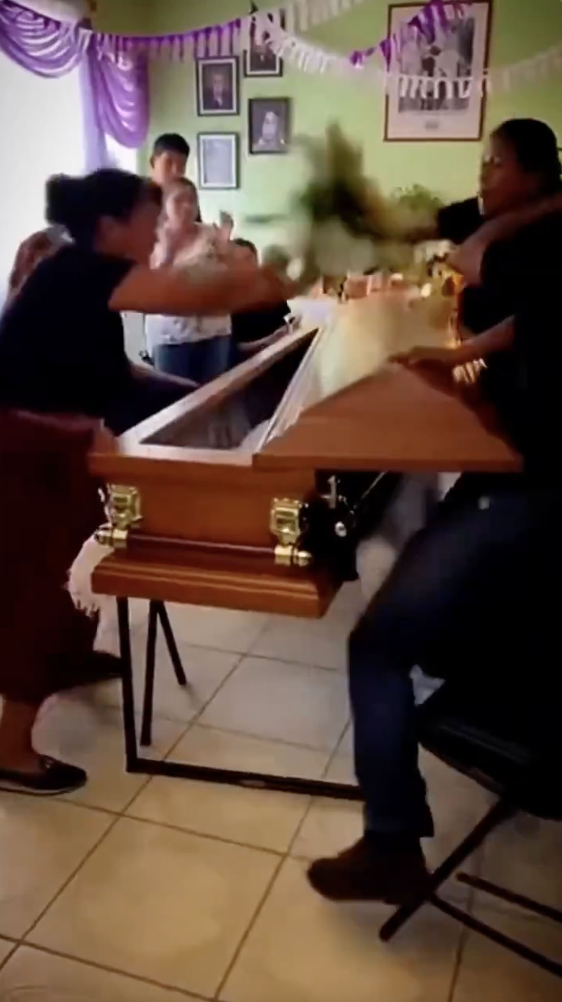 Video captures women fighting across coffin at funeral after learning they both dated the man whose funeral was taking place (video)